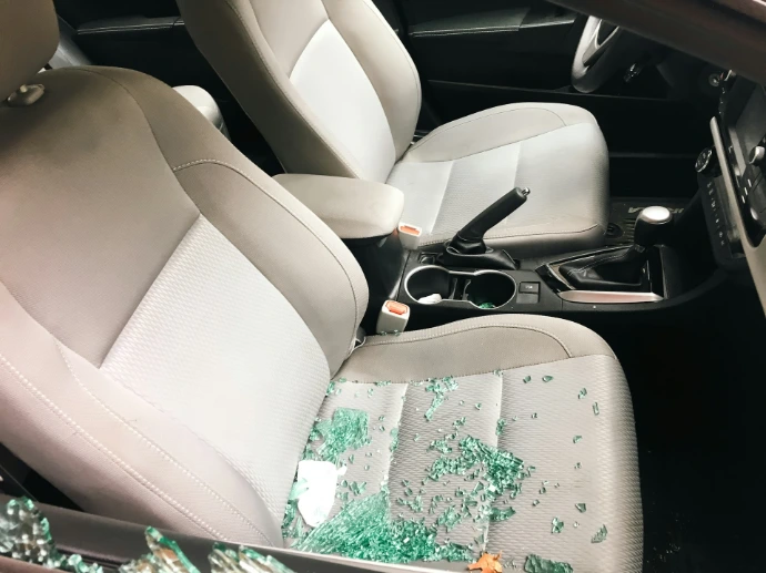 Car interior with shattered glass from a broken window